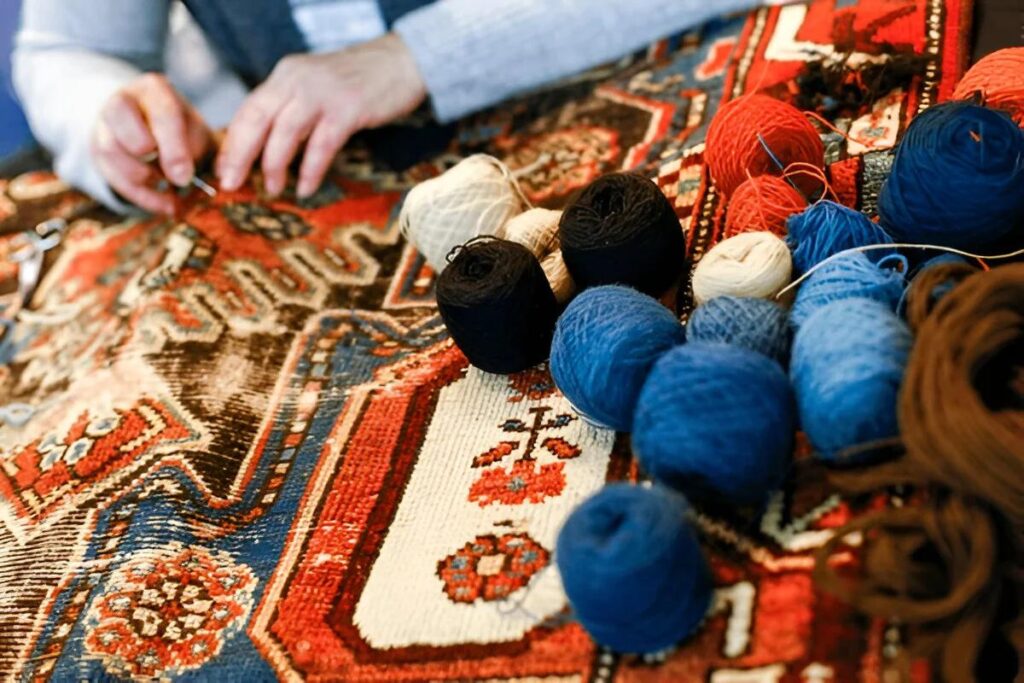 Handmade oriental rug repair close-up showing detailed reweaving and craftsmanship in Dallas Fort Worth